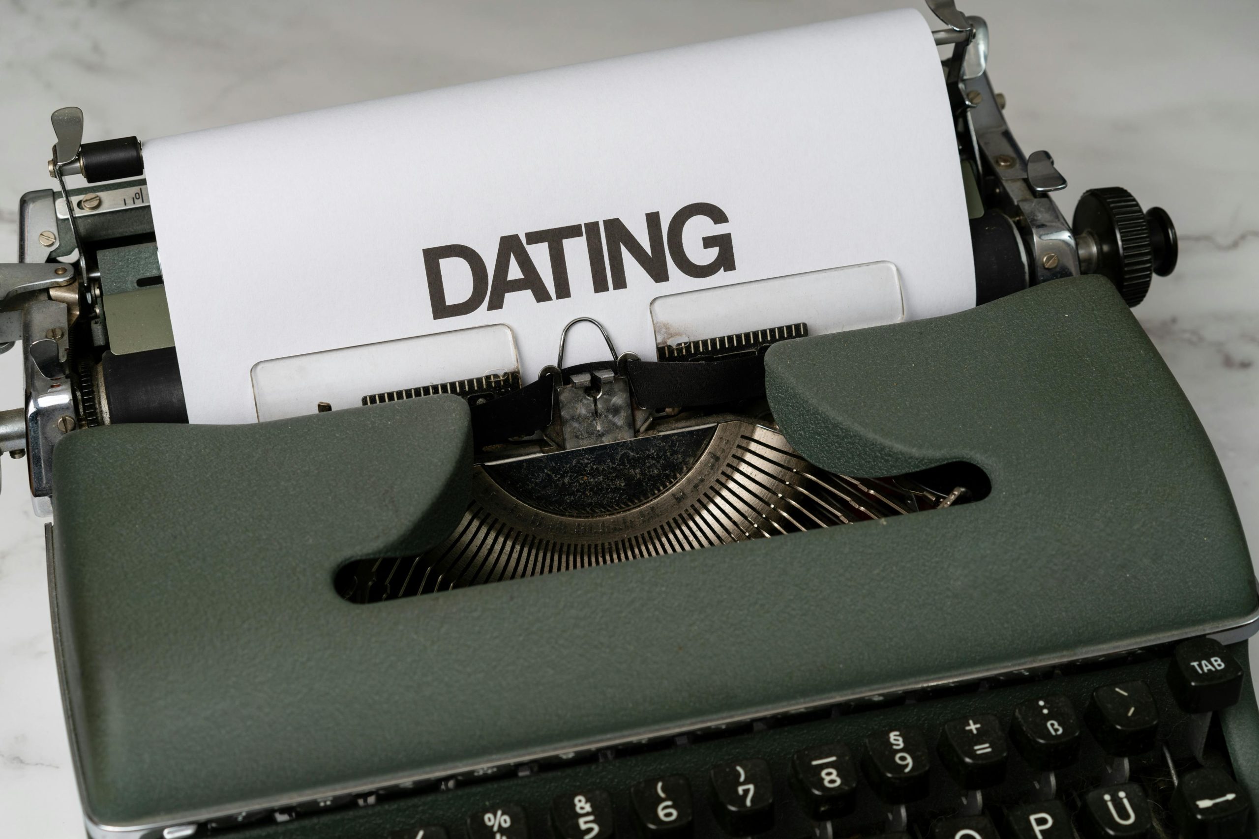 A vintage typewriter showcasing the word 'Dating' on paper, symbolizing classic writing theme.